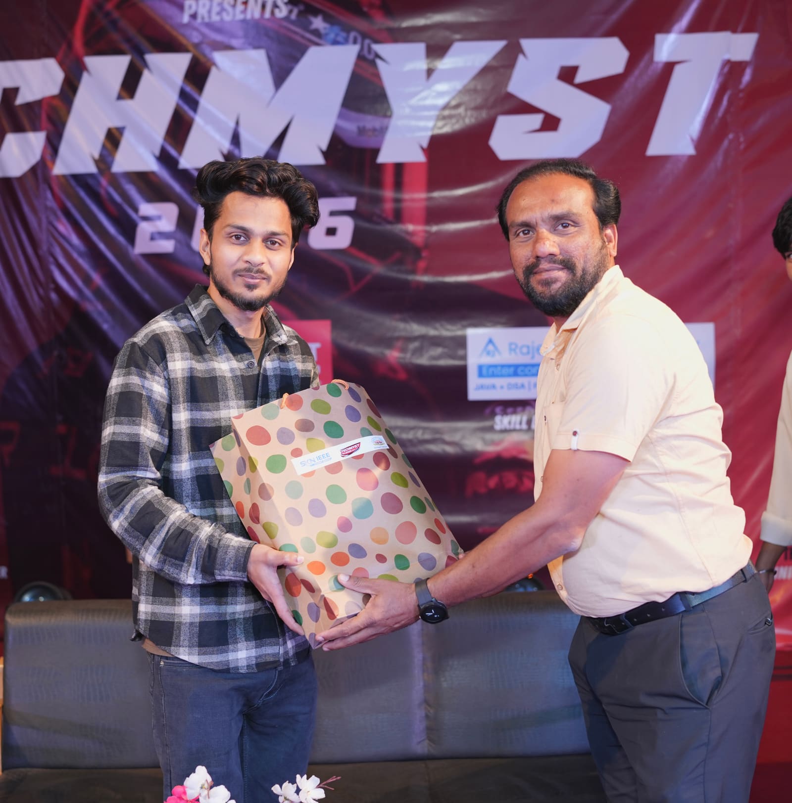 Hassan Ansari receiving a token of appreciation on stage at Techmyst 2026